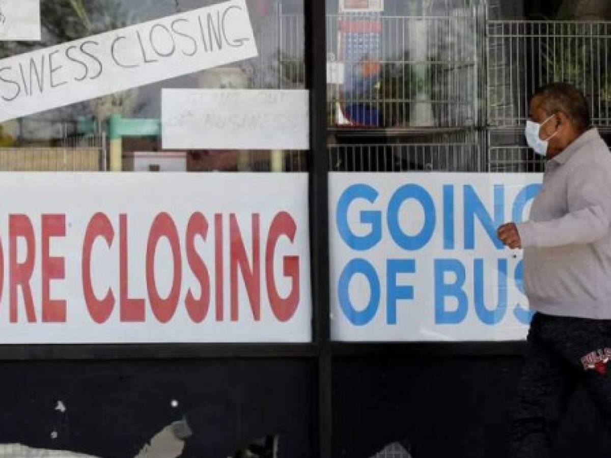 FILE - In this May 21, 2020 file photo, a man looks at signs of a closed store due to COVID-19 in Niles, Ill. U.S. businesses shed 2.76 million jobs in May, as the economic damage from the historically unrivaled coronavirus outbreak stretched into a third month. The payroll company ADP reported Wednesday that businesses have let go of a combined 22.6 million jobs since March.AP Photo/Nam Y. Huh, File)