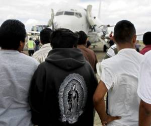 Indocumentados guatemaltecos esperan en la rampa de la Fuerza Aerea Guatemalteca en Ciudad de Guatemala, luego de ser deportados desde Estados Unidos, el 13 de julio de 2007. Mas de 11.200 de los 700.000 guatemaltecos que viven indocumentados en EEUU han sido deportados en los primeros seis meses de 2007, lo que hace vaticinar que las expulsiones alcanzaran una cifra sin precedentes para diciembre, segun cifras de la Direccion General de Migracion. AFP PHOTO/ Orlando SIERRA (Photo by ORLANDO SIERRA / AFP)