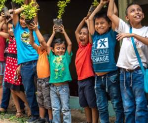 Guazacapan Guatemala 03/20/2019 latin children holding plants in Guatemala