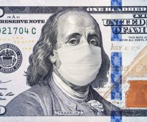 American President with a face mask against CoV infection. 100 dollar banknote. Coronavirus in United States. Concept quarantine and recession. Global economy hit by corona virus outbreak and pandemic