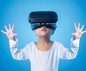 Asian Chinese little girl experiencing virtual reality eyeglassses in isolated background.