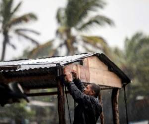 Un hombre protege su casa en Bilwi, Puerto Cabezas, Nicaragua. Eta se mantiene en categoría 4 con vientos de 240km/h y se ubica a poco menos de 40 km al este de la ciudad de Bilwi su velocidad de traslación es de 9km/h. (Photo by INTI OCON / AFP)