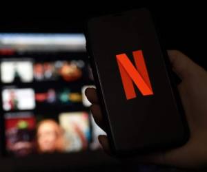 In this photo illustration a computer and a mobile phone screens display the Netflix logo on March 31, 2020 in Arlington, Virginia. (Photo by Olivier DOULIERY / AFP)