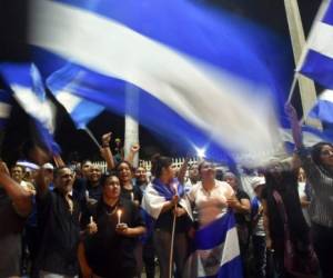 Students from different universities from across Nicaragua demand President Daniel Ortega and his powerful vice president, wife Rosario Murillo, to resign and the government to keep the 6% budget for universities, in Managua, on August 2, 2018.The death toll in violent protests in Nicaragua against Ortega stands at 317, a US-based regional rights group said Thursday. / AFP PHOTO / Marvin RECINOS
