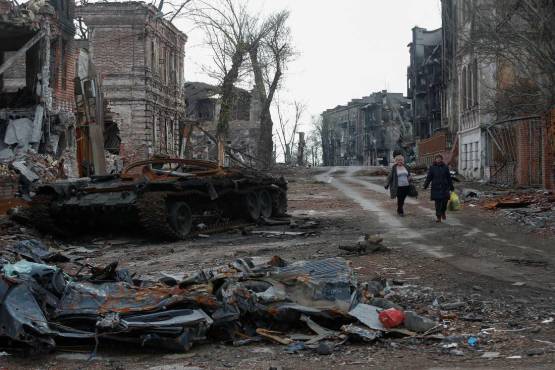 Gente camina en los restos de edificios en Mariupol, Ucrania el 22 de abril, 2022. REUTERS/Alexander Ermochenko