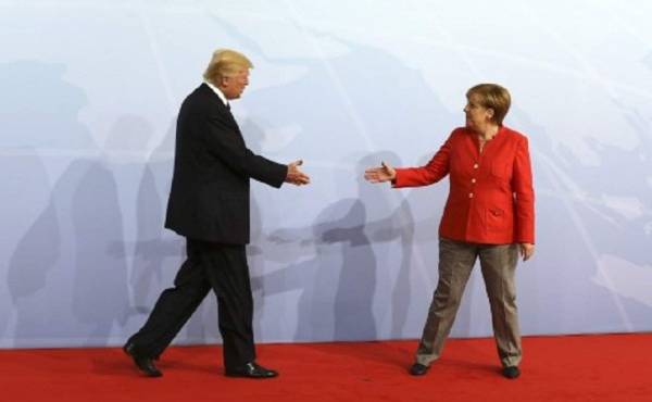 German Chancellor Angela Merkel greets US President Donald Trump at the start of the G20 meeting in Hamburg, northern Germany, on July 7.Leaders of the world's top economies will gather from July 7 to 8, 2017 in Germany for likely the stormiest G20 summit in years, with disagreements ranging from wars to climate change and global trade. / AFP PHOTO / AFP PHOTO AND POOL / LUDOVIC MARIN / SOLELY FOR REUTERS