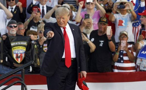Former US President Donald Trump points to the crowd as he arrives for his campaign-style rally in Wellington, Ohio, on June 26, 2021. - Donald Trump held his first big campaign-style rally since leaving the White House, giving a vintage, rambling speech Saturday to an adoring audience as he launched a series of appearances ahead of next year's midterm elections.The former president, who has been booted from social media platforms and faces multiple legal woes, has flirted with his own potential candidacy in 2024, but in the 90-minute address at a fair grounds in Ohio he made no clear mention of his political future, even when the crowd chanted 'four more years! four more years!' (Photo by STEPHEN ZENNER / AFP)