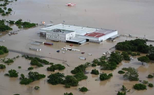 Aerial view of a factory in the municipality of La Lima, on the outskirts of San Pedro Sula, 240 km north of Tegucigalpa, flooded due to the overflowing of the Chamelecon river after the passage of Hurricane Iota, taken on November 18, 2020. - Storm Iota, which made landfall in Nicaragua as a 'catastrophic' Category 5 hurricane Monday, killed at least ten people as it smashed homes, uprooted trees and swamped roads during its destructive advance across Central America. (Photo by Orlando SIERRA / AFP)