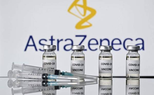 An illustration picture shows vials with Covid-19 Vaccine stickers attached and syringes with the logo of British pharmaceutical company AstraZeneca on November 17, 2020. (Photo by JUSTIN TALLIS / AFP)