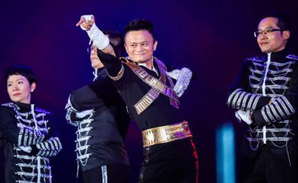 This photo taken on September 8, 2017 shows Jack Ma, chairman of Alibaba group, dancing to a medley of Michael Jackson songs during the Alibaba Annual Party at the Huanglong sports center in Hangzhou in China's eastern Zhejiang province. Ma danced with other Alibaba employees during the party, which was held to celebrate the 18th anniversary of the company's founding. / AFP PHOTO / STR / China OUT