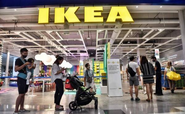 People queue up to enter IKEA as it reopened after restrictions to halt the spread of the COVID-19 coronavirus were lifted in Bangkok on May 17, 2020. (Photo by Lillian SUWANRUMPHA / AFP)
