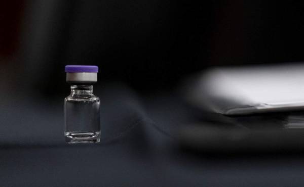 WASHINGTON, DC - DECEMBER 10: An example of the Pfizer COVID-19 vaccine vial is visible on a desk before a Senate Transportation subcommittee hybrid hearing on transporting a coronavirus vaccine on Capitol Hill, on December 10, 2020 in Washington, DC. Andrew Harnik-Pool/Getty Images/AFP