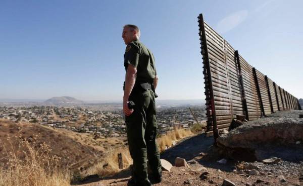 A Border Patrol agent looks for footprints from illegal immigrants crossing the U.S.- Mexico border in 2010. Traffickers have begun using immigrants as drug smugglers, recruiting voluntarily and forcibly.