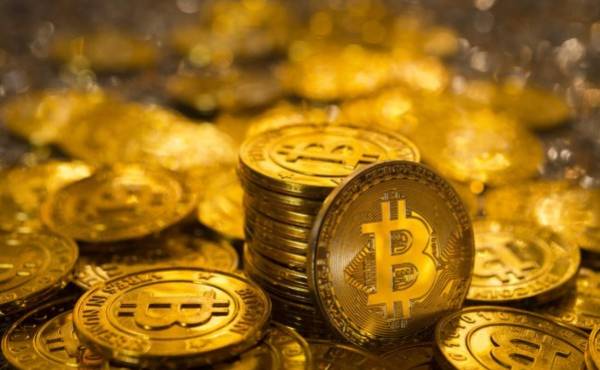 Izmir, Turkey - January 12, 2018: Bunch of memorial golden bitcoins. Bitcoin is a worldwide digital currency that isn't controlled by a central authority such as a government or bank.