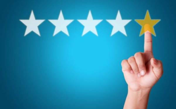 Businesswoman touching five star symbol to increase rating of company
