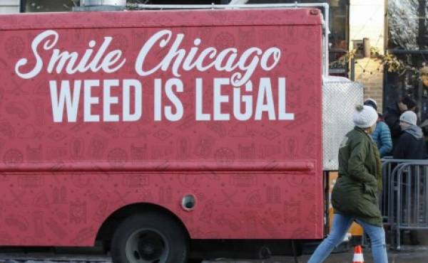 A food truck sits outside the Sunnyside Cannabis Dispensary as customers wait in line to buy marijuana, on January 1, 2020 in Chicago, Illinois. - On the first day of 2020, recreational marijuana became legal in Illinois, which joins 10 other US states with legal use of recreational marijuana. (Photo by KAMIL KRZACZYNSKI / AFP)