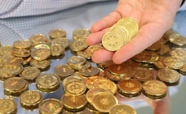 SALT LAKE CITY, UT - APRIL 26: Software engineer Mike Caldwell holds physical Bitcoins he minted in his shop on April 26, 2013 in Sandy, Utah. Bitcoin is an experimental digital currency used over the Internet that is gaining in popularity worldwide. (Photo by George Frey/Getty Images)